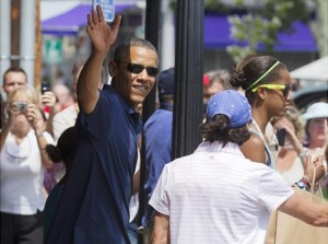 Obama and family wave to the crowd while vacationing on Martha's Vineyard